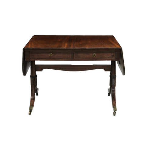 781 - A Regency mahogany sofa table with two drawers with brass handles and ebony stringing, and a shaped ... 