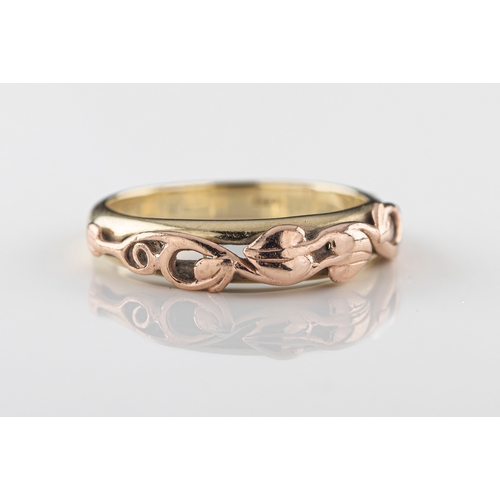 84 - Clogau - a 9ct yellow and rose gold ring the yellow gold band applied with Arts and Crafts style ros... 