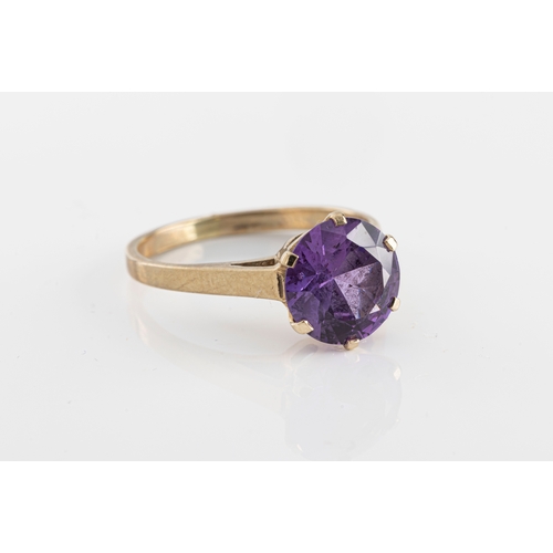 97 - A 9ct yellow gold and amethyst solitaire ring the round cut amethyst in a six claw setting, ring siz... 