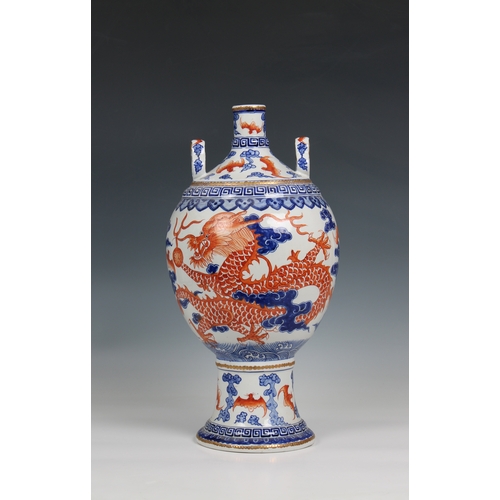 1176 - A 19th century Chinese porcelain vase the ovoid body with rouge de feu and blue decoration of dragon... 