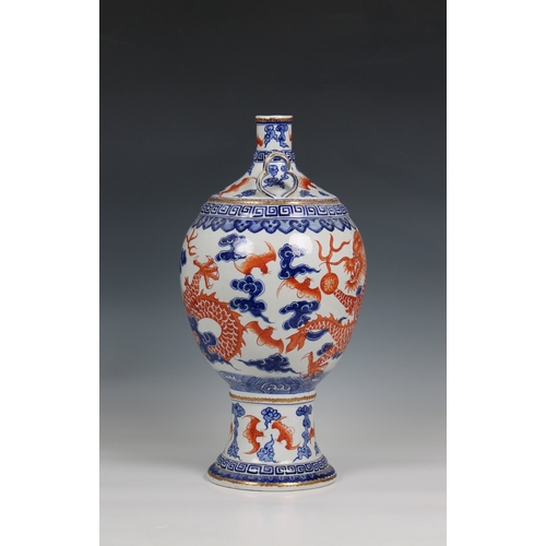 1176 - A 19th century Chinese porcelain vase the ovoid body with rouge de feu and blue decoration of dragon... 