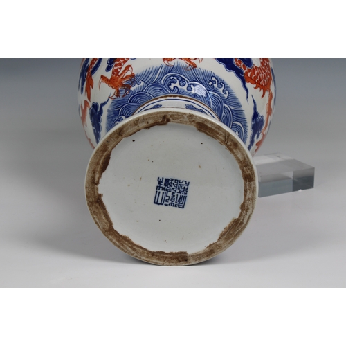 1176 - A 19th century Chinese porcelain vase the ovoid body with rouge de feu and blue decoration of dragon... 