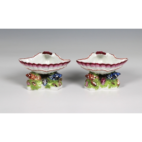 386 - A pair of Bow porcelain sweetmeat stands circa 1765 in the form of upturned scallop shells nestled o... 