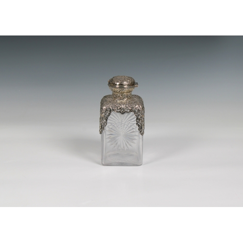 528 - A Victorian cut glass scent bottle with silver mounts Birmingham 1893, 6¾in. (17.1cm.) high.