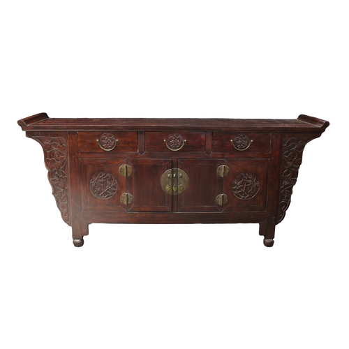 660 - A Chinese hardwood low chest late 19th / early 20th century, the rolled top over three short drawers... 