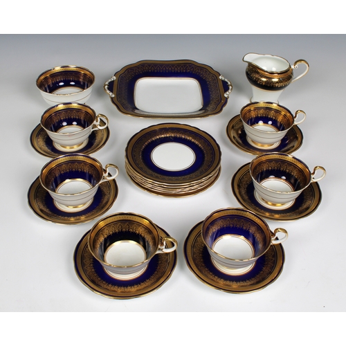 377 - An elegant cobalt blue and gilded Aynsley part tea service comprising serving plate, sugar bowl, jug... 