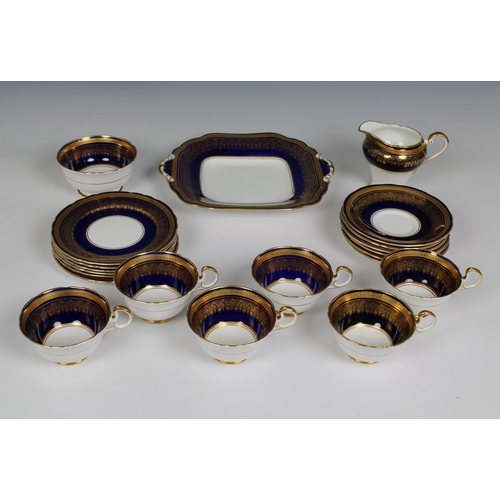 377 - An elegant cobalt blue and gilded Aynsley part tea service comprising serving plate, sugar bowl, jug... 