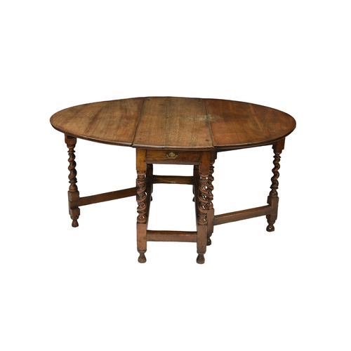 782A - A 17th century and later English oak gate leg oval table with two demi lune drop leaves over a singl... 