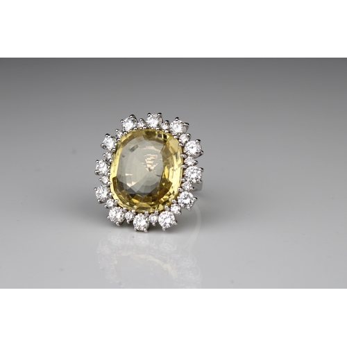 313 - A yellow sapphire and diamond dress ring set in 18ct. white gold, the central stone an important yel... 