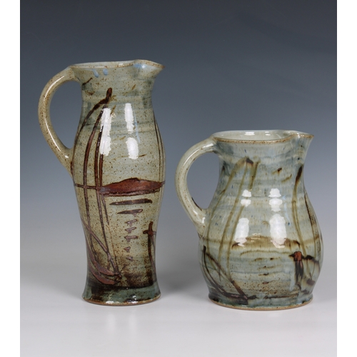 100 - Two studio pottery jugs in an automnal palette, the tallest 13¾in. (35cm.) tall. (2)