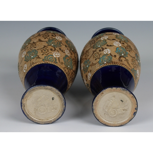 110 - A pair of Doulton Lambeth Slater's Patent vases of shouldered ovoid form with slender necks and ever... 