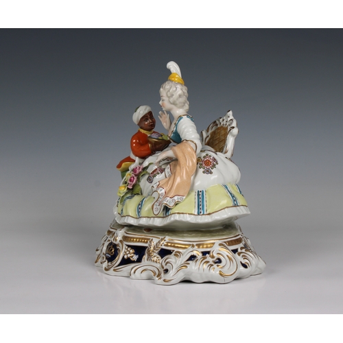 112 - A Meissen style porcelain figural group of a seated lady and servant having blue cross sword mark wi... 