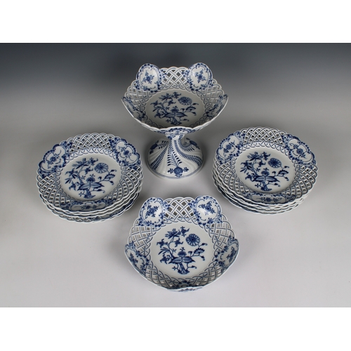 113 - A Meissen blue and white onion pattern part dessert service with reticulated borders comprising a ta... 