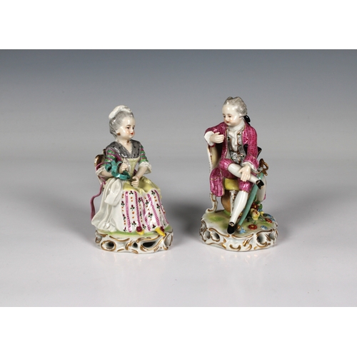 119 - A pair of Sampson porcelain figurines modelled depicting a seated young lady and a dandy, with gold ... 