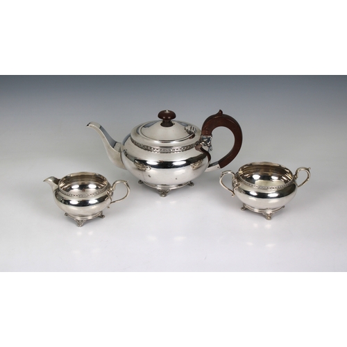 214 - A George V silver three piece tea service Martin Hall & Co, Sheffield, 1927, of compressed spherical... 