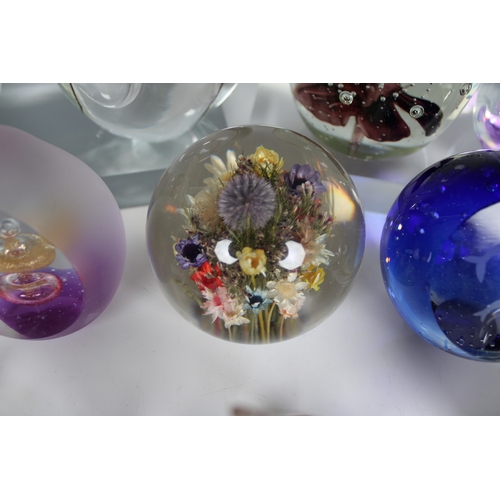 22 - A large collection of glass paperweights various sizes and shapes, unmarked, together with three res... 