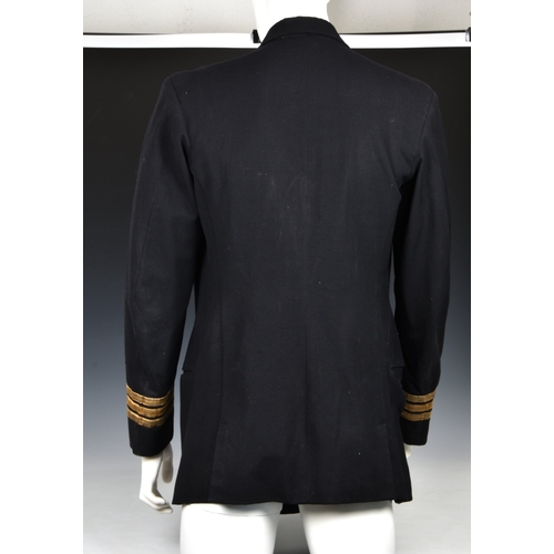 220 - A Royal Navy Uniform Jacket having mounted medal ribbons, bullion wire cuff braid for the rank of Co... 