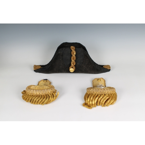 228 - An Edwardian full dress Royal Navy bicorn cocked hat, pair of epaulettes and sword belt in a fitted ... 