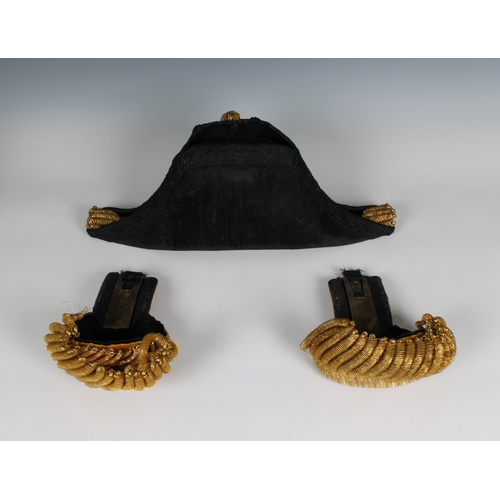 228 - An Edwardian full dress Royal Navy bicorn cocked hat, pair of epaulettes and sword belt in a fitted ... 