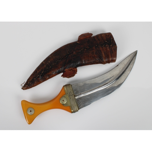 260 - A Middle Eastern Jambiya dagger with yellow metal mounted amber colour bakelite handle, characterist... 