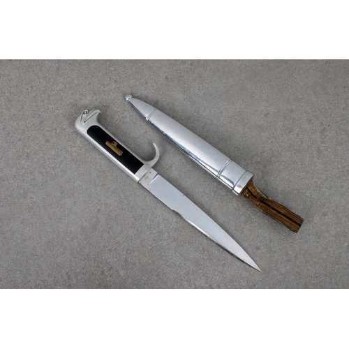 265 - An Italian MVSN (Opera Balilla) officer's dagger aluminium hilt, equipped with inlaid black celluloi... 