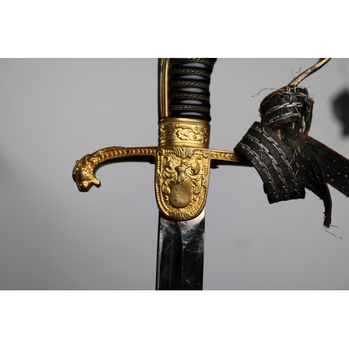 284 - An Imperial German Uhlan Regiment Officers Sword slightly curved 84cm. steel blade, gilt guard, cros... 