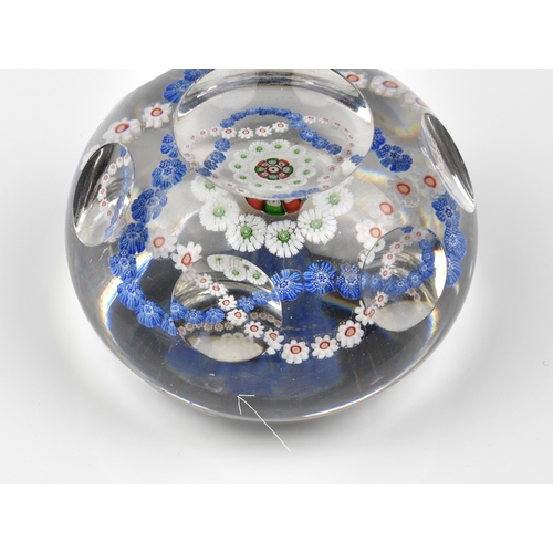 29 - A Baccarat facetted / patterned millefiori glass paperweight the clear glass set with a trefoil garl... 