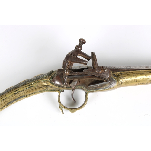 290 - A 19th century Balkan Miquelet flintlock pistol the full stock and rat tail butt clad with engraved ... 