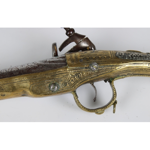 290 - A 19th century Balkan Miquelet flintlock pistol the full stock and rat tail butt clad with engraved ... 