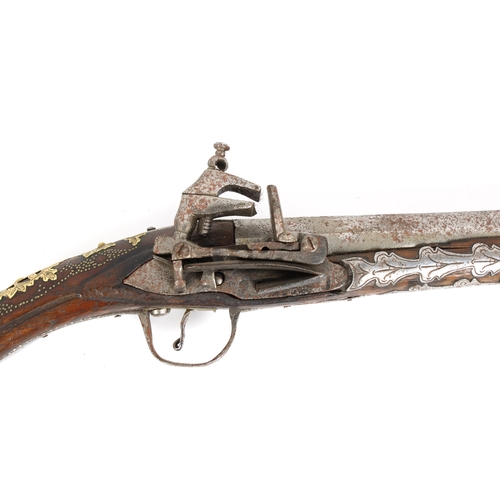 293 - A late 18th or early 19th century Balkan Miquelet flintlock pistol, the rat tail butt in sheet brass... 