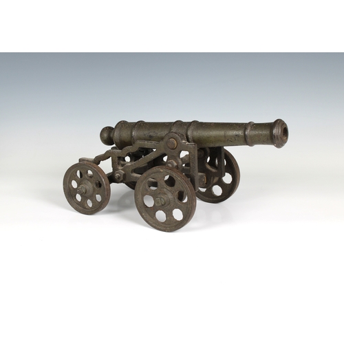 297 - A model cannon with an iron barrel and iron four wheeled gun carriage barrel 13 1/5in. (33.5cm.), bo... 