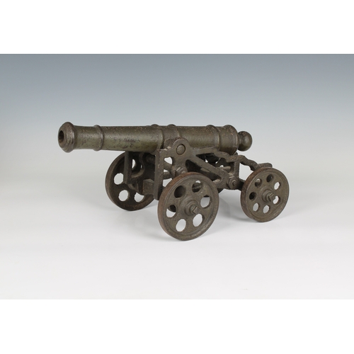 297 - A model cannon with an iron barrel and iron four wheeled gun carriage barrel 13 1/5in. (33.5cm.), bo... 