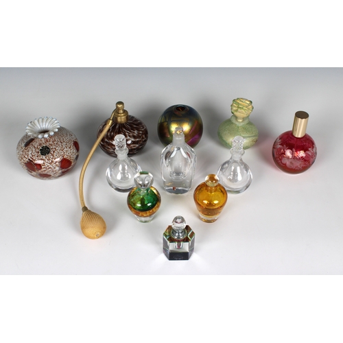 38 - A collection of glass perfume bottles and vases varying sizes, comprising an Isle of Wight Studio gr... 