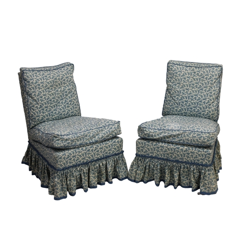 493 - A pair of Howard slipper chairs with blue floral fabric, bearing label for 