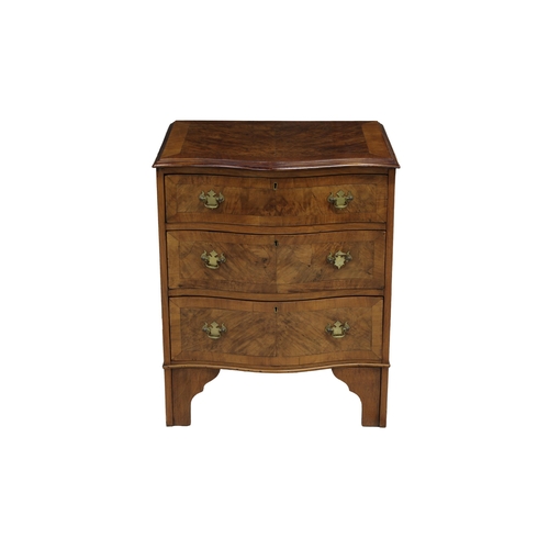 495 - A George III style serpentine walnut chest of drawers the stepped top over three crossbanded graduat... 