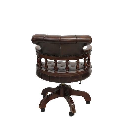 496 - A 20th century Victorian style button back brown leather Captains chair with wood turned spindles, s... 