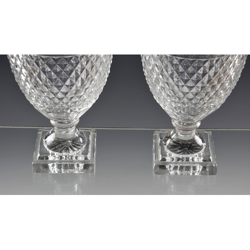 51 - A good pair of early 19th century Voneche cut glass urn shaped jars and covers lemon squeezer base, ... 