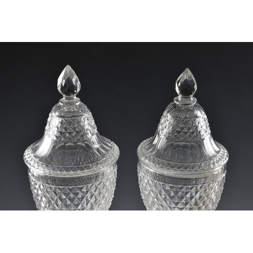 51 - A good pair of early 19th century Voneche cut glass urn shaped jars and covers lemon squeezer base, ... 