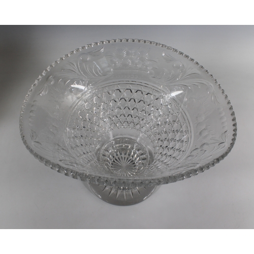 53 - A cut glass footed vase of ovoid form with a flared rim on a circular base scrolling and floliate de... 