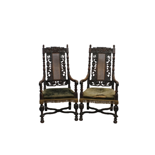 532 - A pair of 19th century Carolean style carved wooden open armchairs the backs with floral carved cres... 