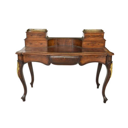 538 - A Louis XVI style serpentine rosewood bureau plat the raised drawer sections with pierced brass rail... 