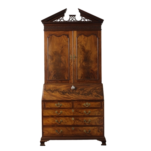 545 - A George III mahogany bureau bookcase with a broken pierced pediment over a blind fret and dental fr... 