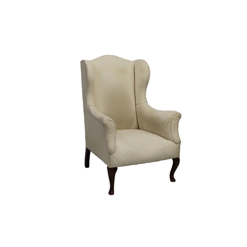 556 - A vintage white upholstered wingback chair.