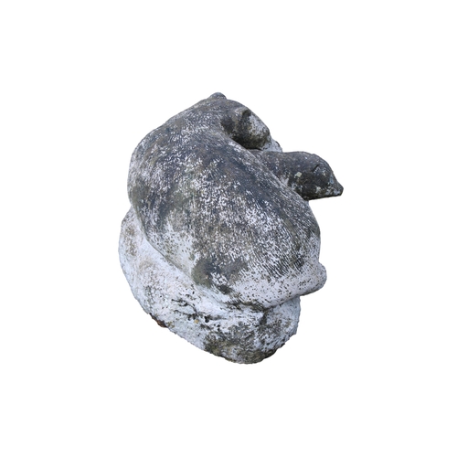 578 - A composite stone figure of a pair of otters 20in. (50.8cm.) long.