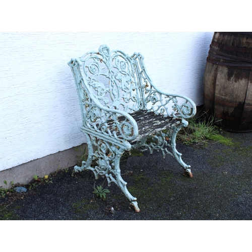 580 - A Victorian painted cast iron garden seat with arms, in the manner of Coalbrookdale fruiting vine de... 