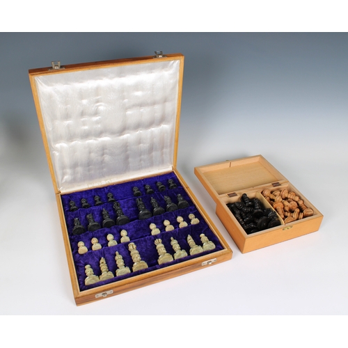 598 - A cased chess set with carved soapstone pieces together with carved wooden chess pieces, both comple... 