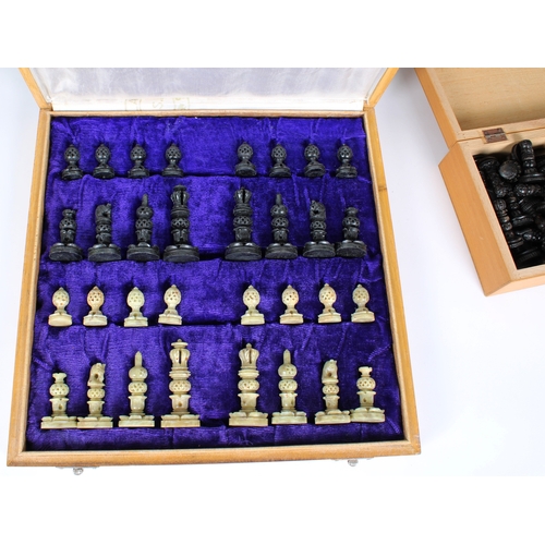 598 - A cased chess set with carved soapstone pieces together with carved wooden chess pieces, both comple... 