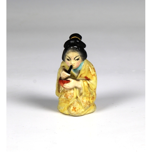 61 - A Royal Worcester figural candle snuffer fashioned as a Japanese Geisha girl, puce mark, 2¾in. (7cm.... 