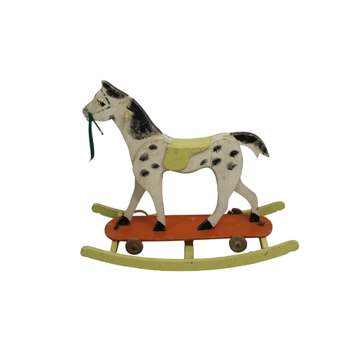 620 - A 1950's combined wooden rocking horse and pull toy hand painted with wooden wheels and butterfly sc... 