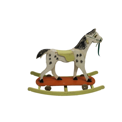 620 - A 1950's combined wooden rocking horse and pull toy hand painted with wooden wheels and butterfly sc... 